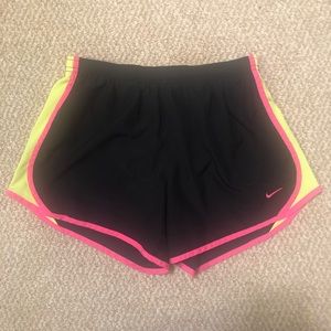 Black pink and yellow girl’s Nike running shorts